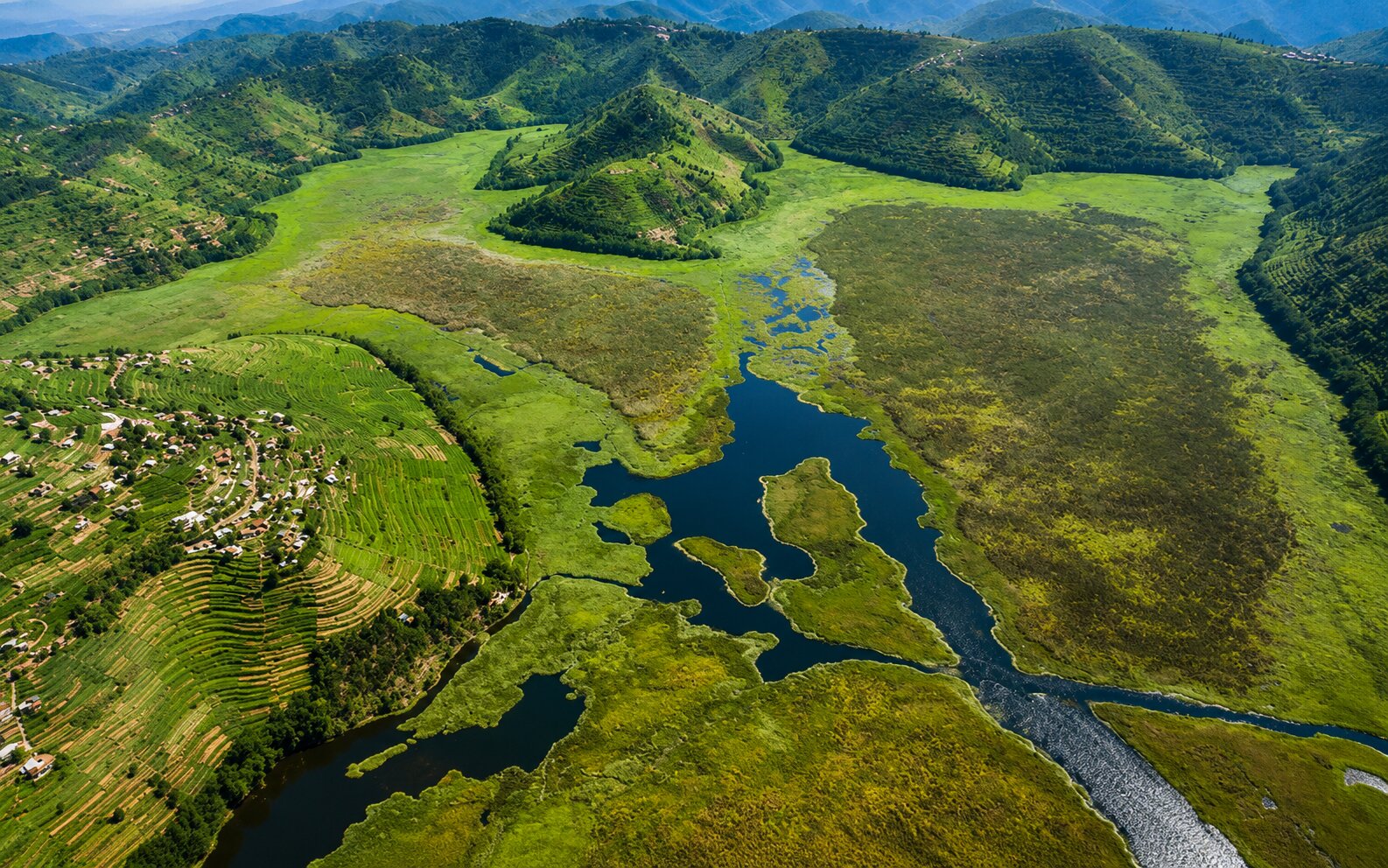 Overhead Drone View Of A Rwandan Village River And Mountain Range