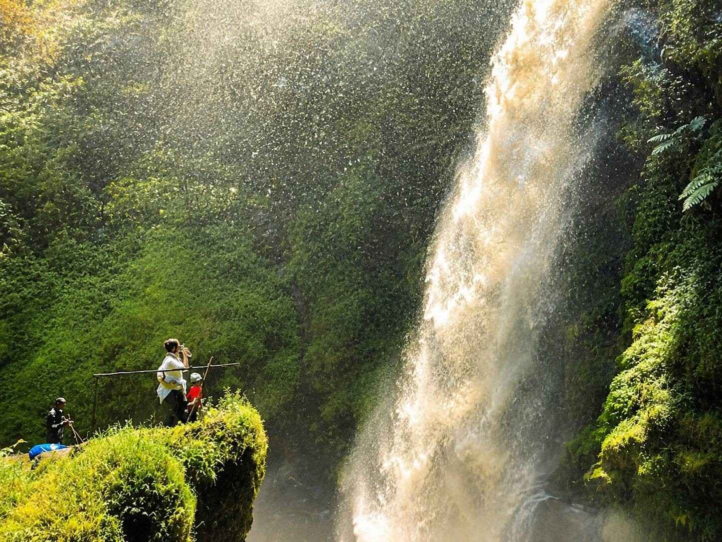 People Staring At A Waterfall In Nyungwe National Park