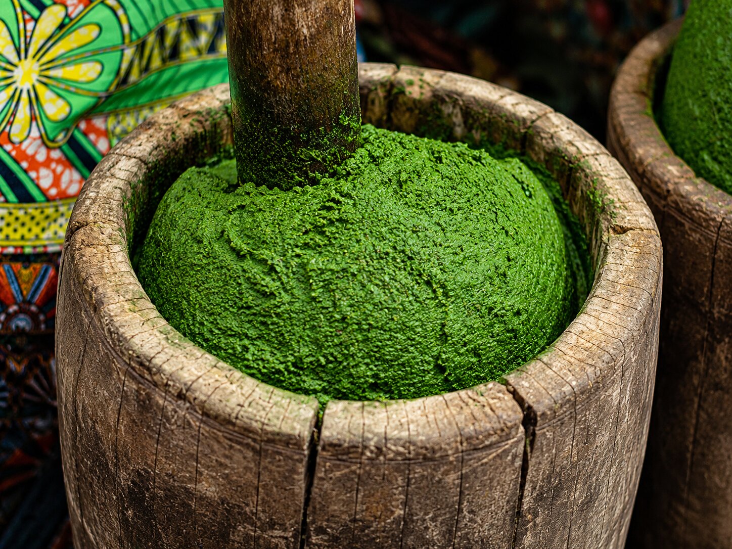 Preparation Of Isombe Being Mushed Into Paste
